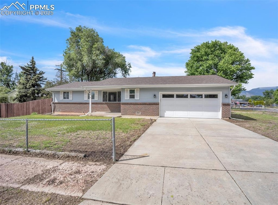 Ranch-style house with brick siding, a garage, and driveway
