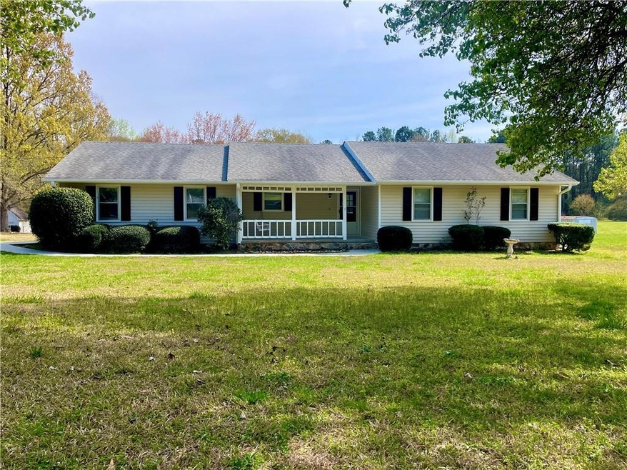 Ranch-style home with a porch and a front lawn