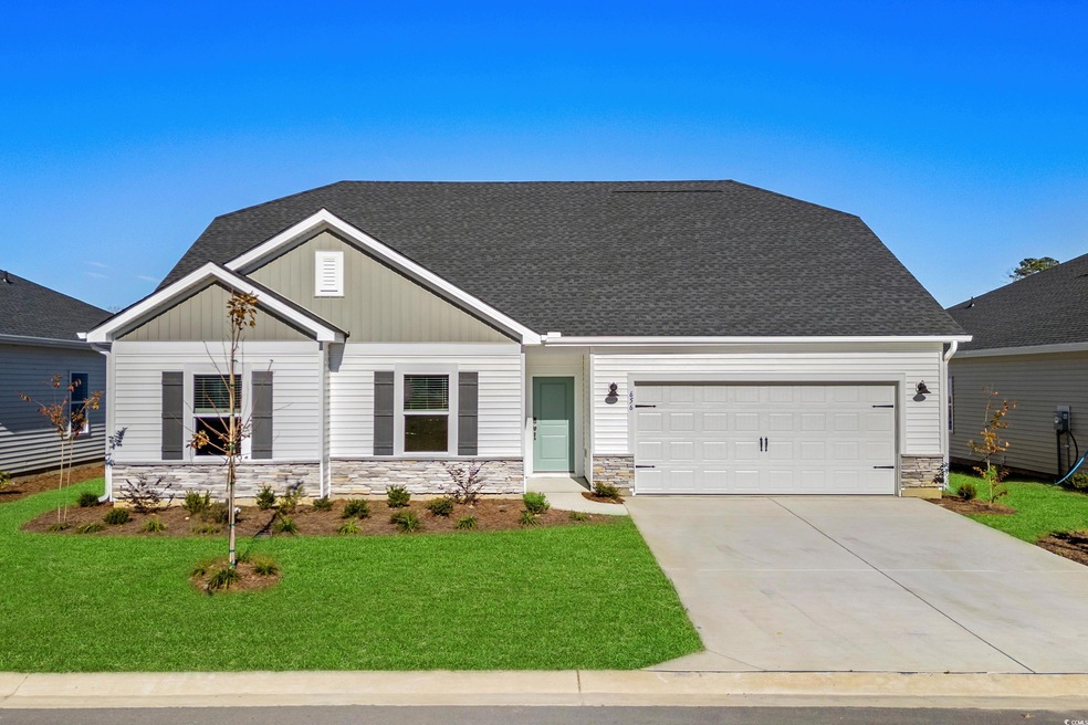 View of front of house with a front yard and a gar