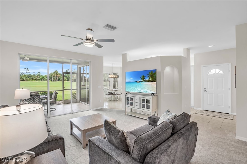 Tiled living room featuring ceiling fan