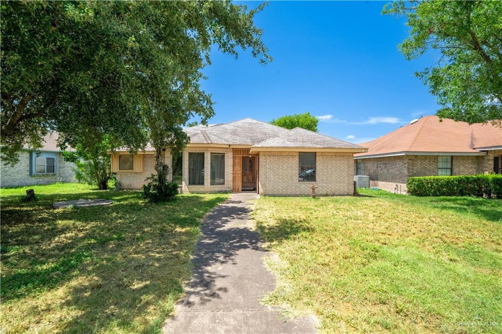 Ranch-style home with brick siding and a front yard