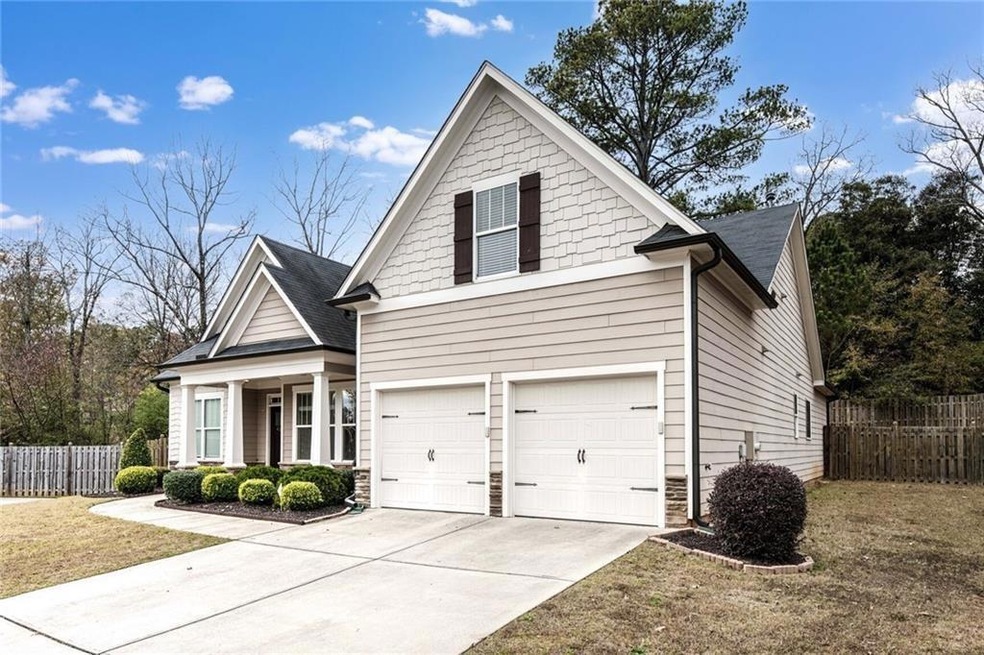 View of front of home featuring driveway, a garage