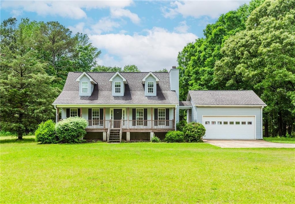 New england style home with covered porch, a chimn