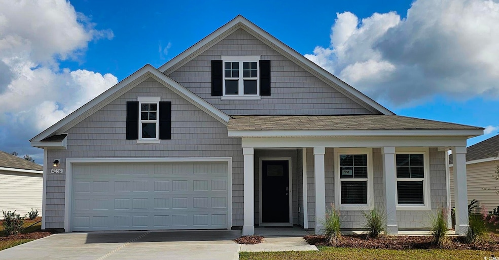 View of front of house featuring a shingled roof, 