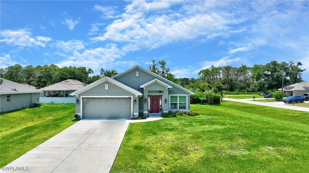 View of front of house with a garage and a front yard