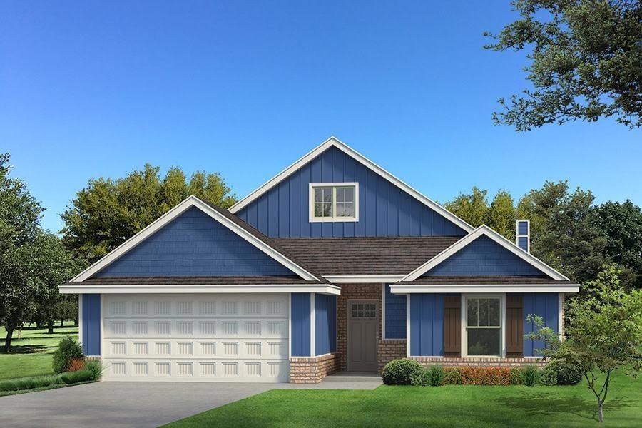 View of front facade featuring driveway, a front y