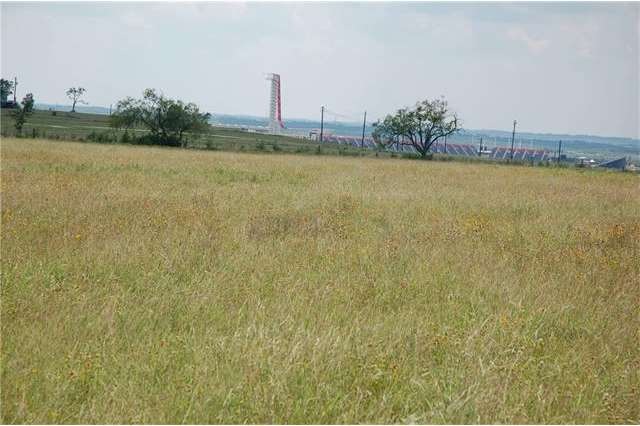 Clear, mostly-level pasture type land with some ge