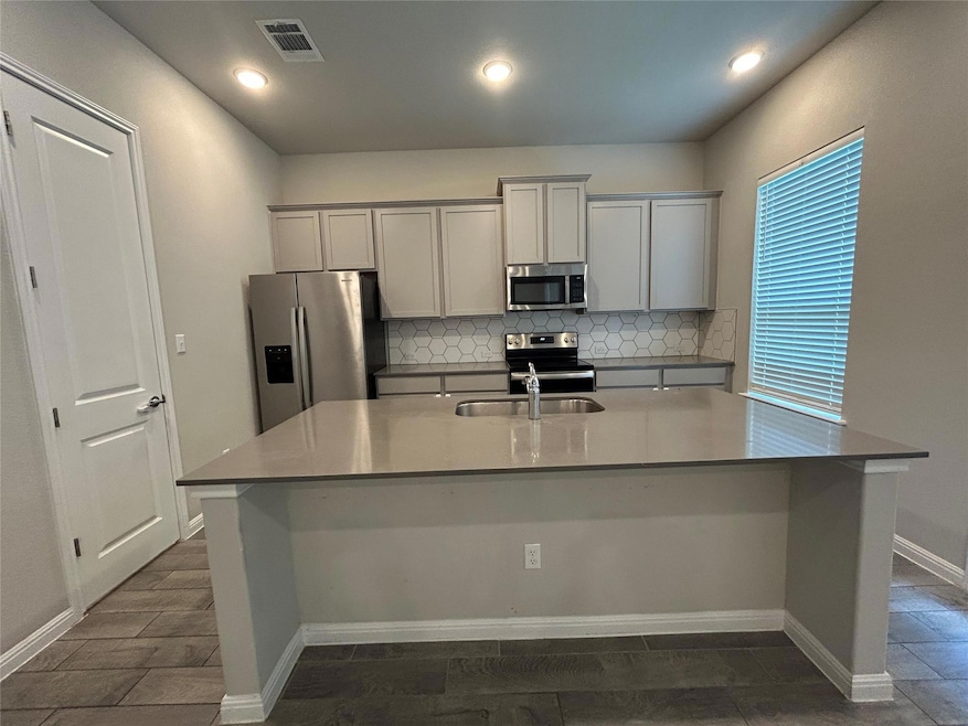 Kitchen featuring appliances with stainless steel