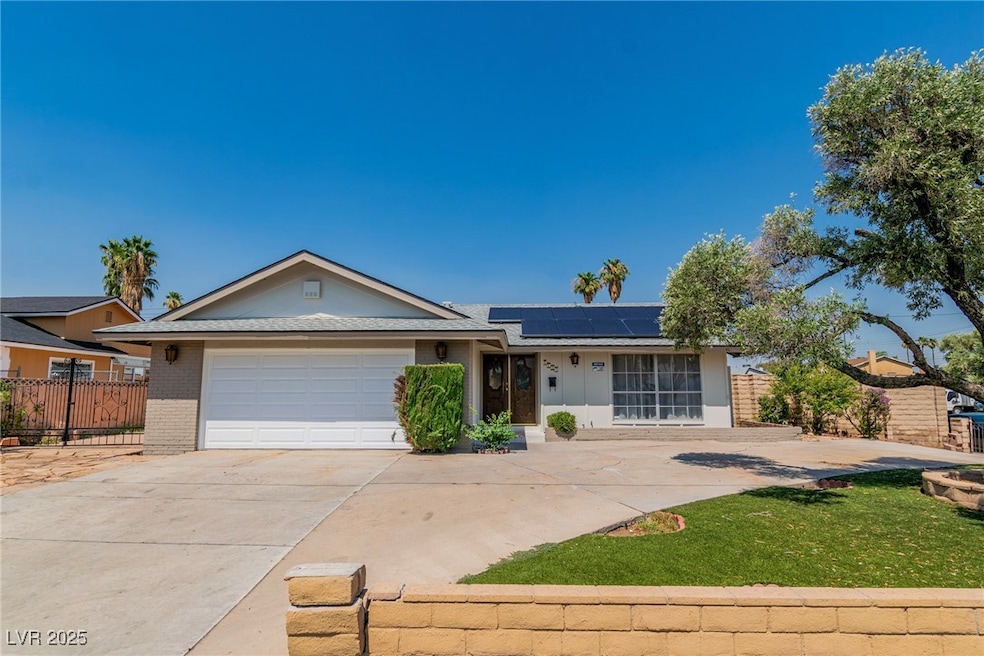 Single story home featuring brick siding, concrete
