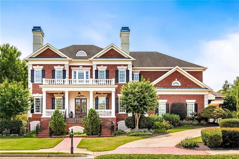 View of front facade with a front lawn and covered