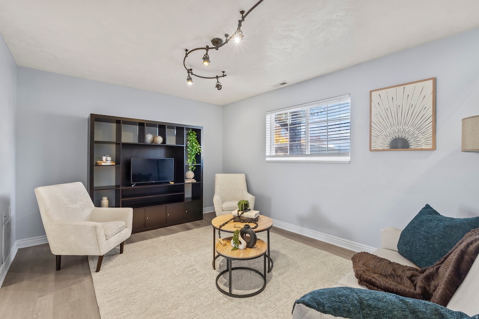 Sitting room with wood finished floors and track lighting