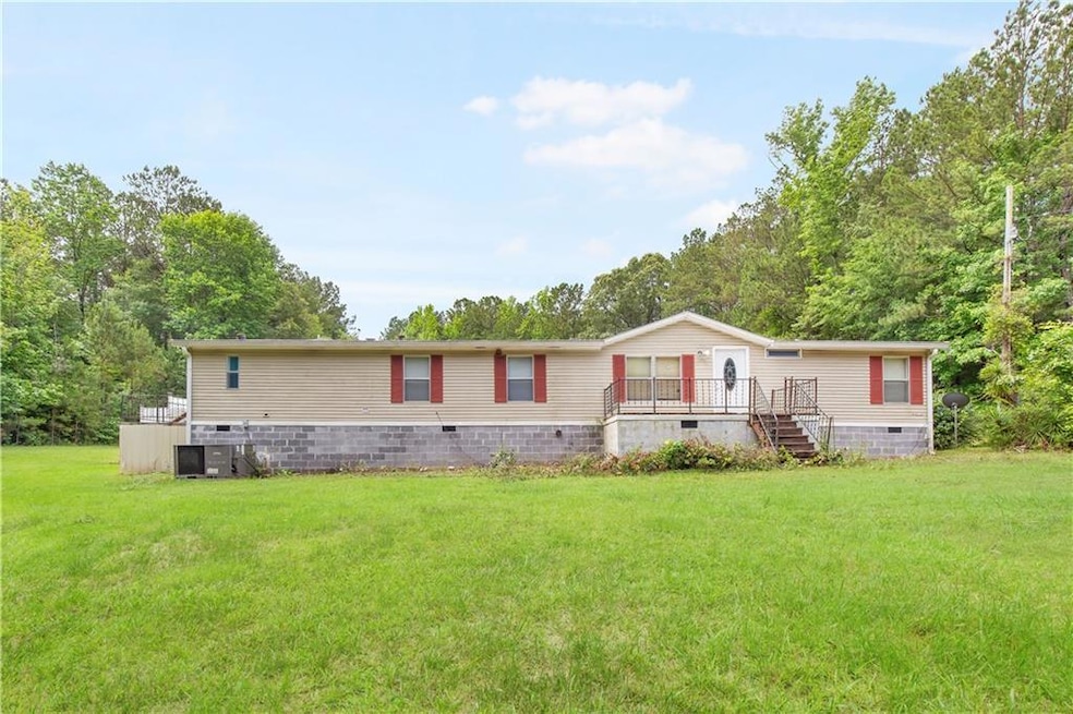 Manufactured / mobile home with crawl space, a front lawn, central AC unit, and a deck