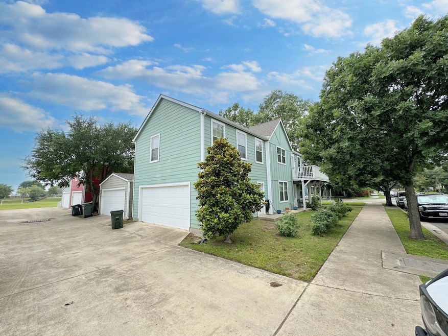 View of side of home with concrete driveway