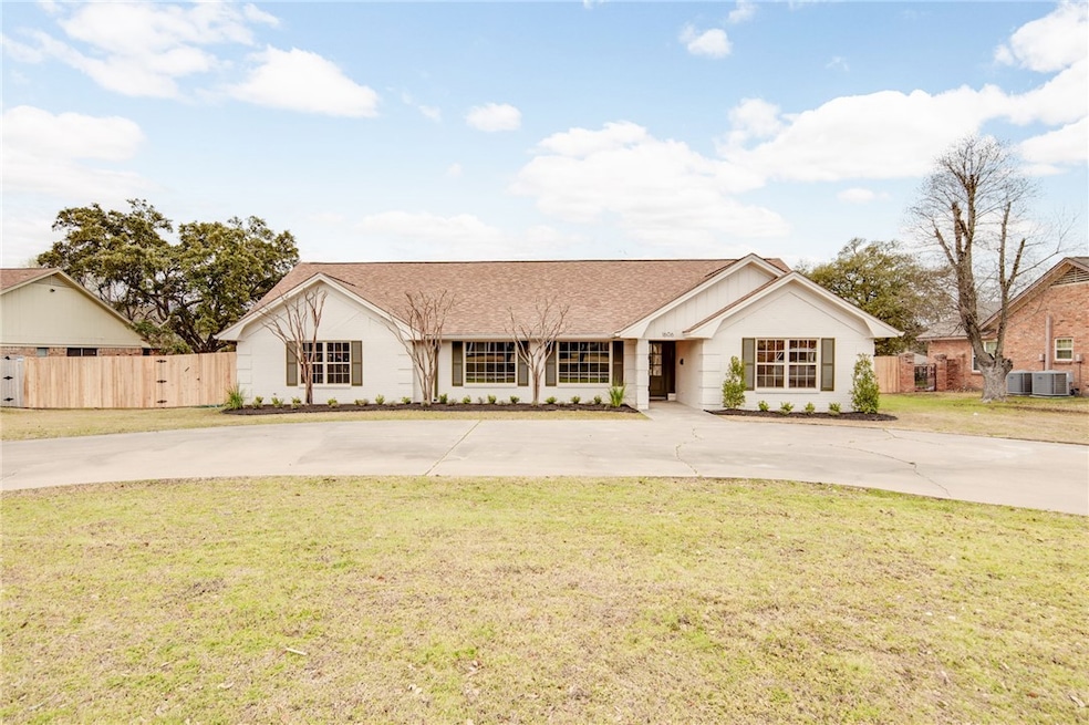 View of front facade with curved driveway, central