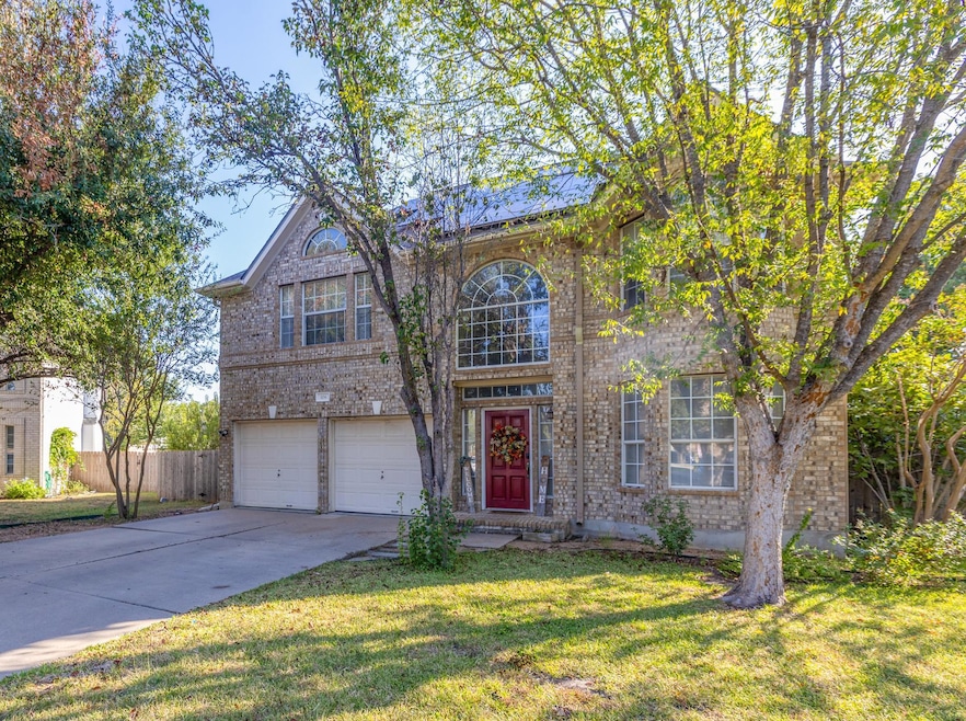 Traditional-style home with brick siding, concrete driveway, and a garage