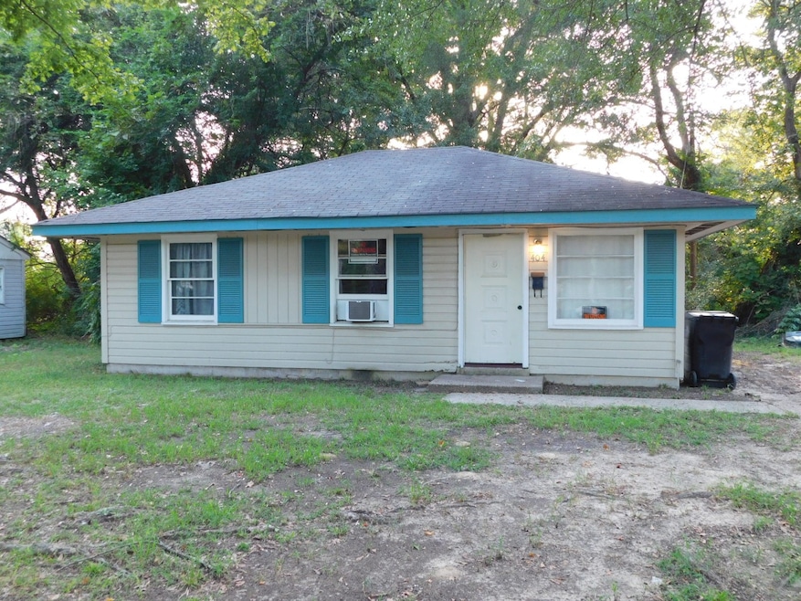 View of front of home featuring a shingled roof and an outdoor structure