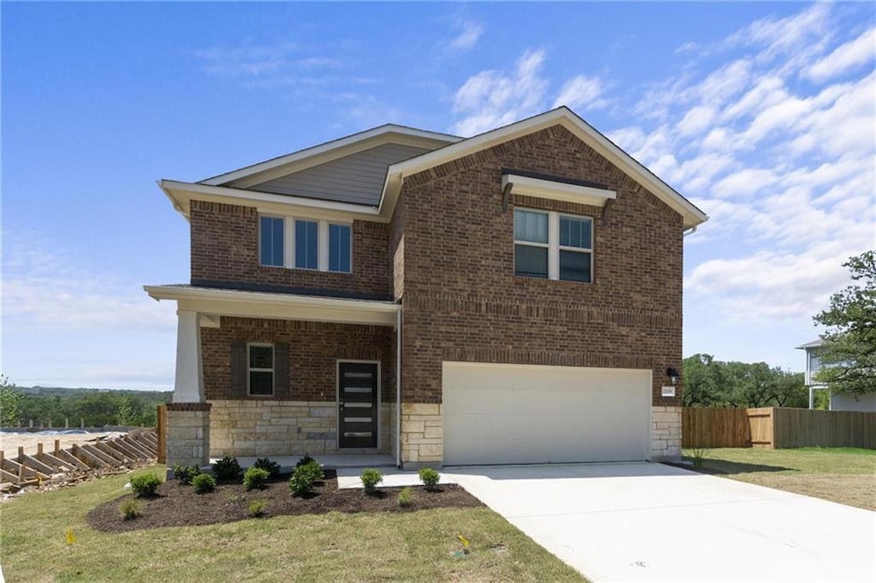 View of front facade featuring a garage, driveway