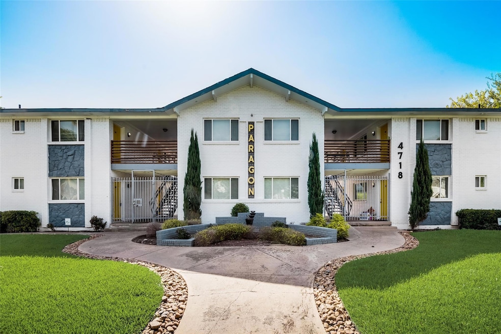 View of front of house featuring a balcony, brick 