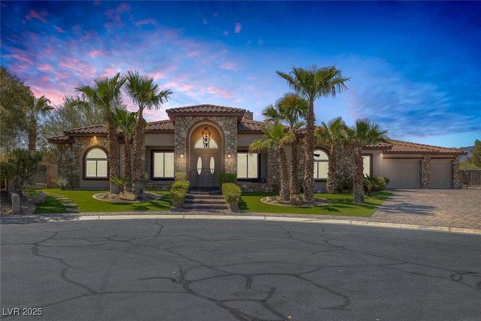 Mediterranean / spanish house with stucco siding, stone siding, decorative driveway, an attached garage, and a tiled roof