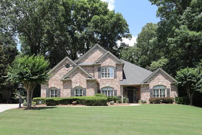 Beautiful 3-side brick home on a landscaped, tree-