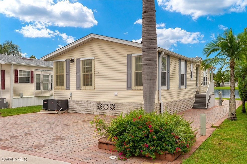 View of side of home with central AC and a patio a
