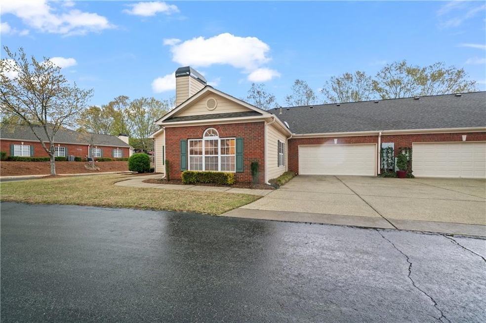 View of front of home with driveway, brick siding,