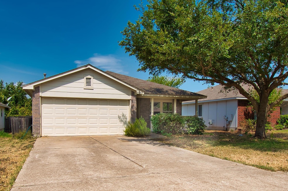 Single story home featuring brick siding, concret