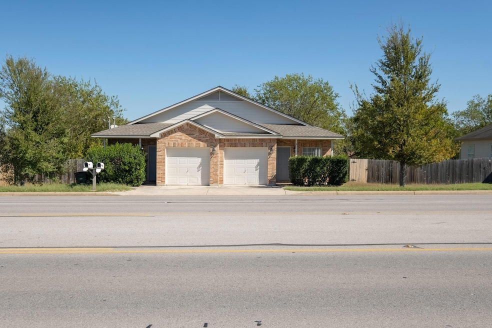 View of front of property featuring a garage, con