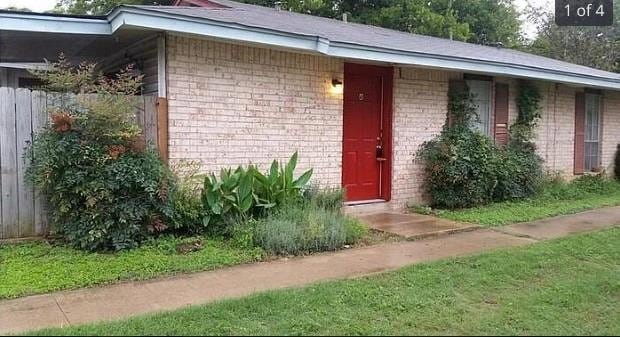View of exterior entry featuring brick siding