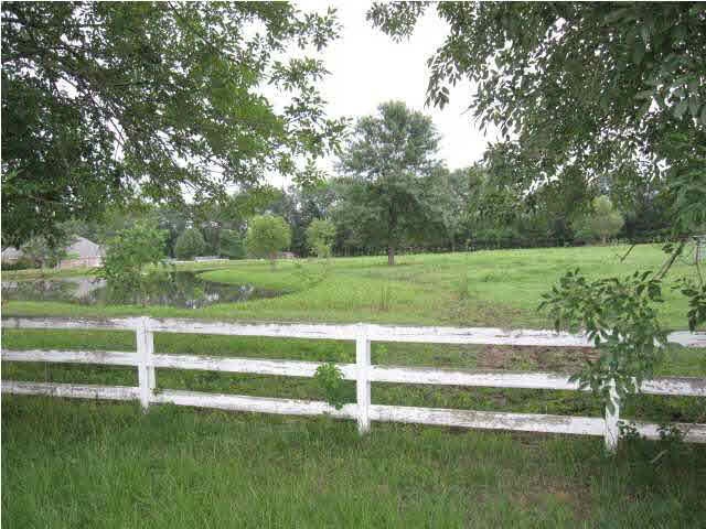 Beautiful fenced land with a pond