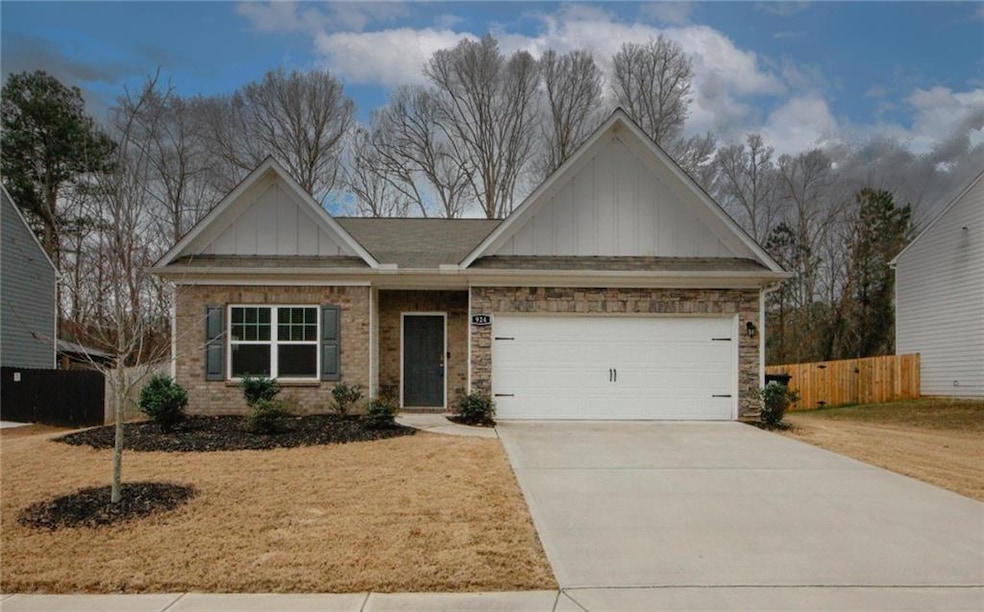View of front facade with an attached garage, bric