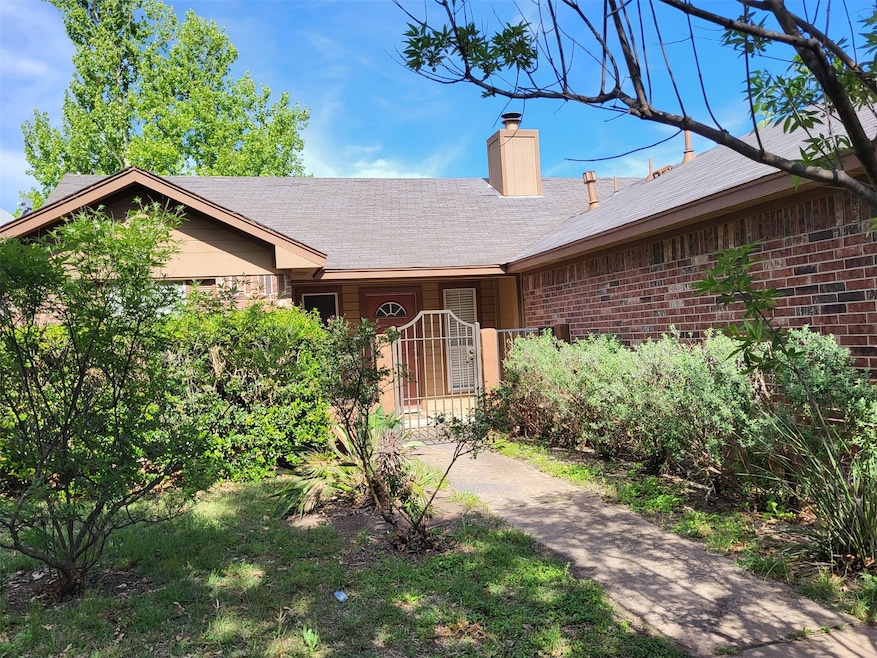 View of front of property with a chimney, brick s
