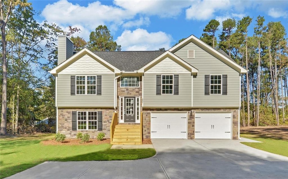 Raised ranch featuring a front yard and a garage