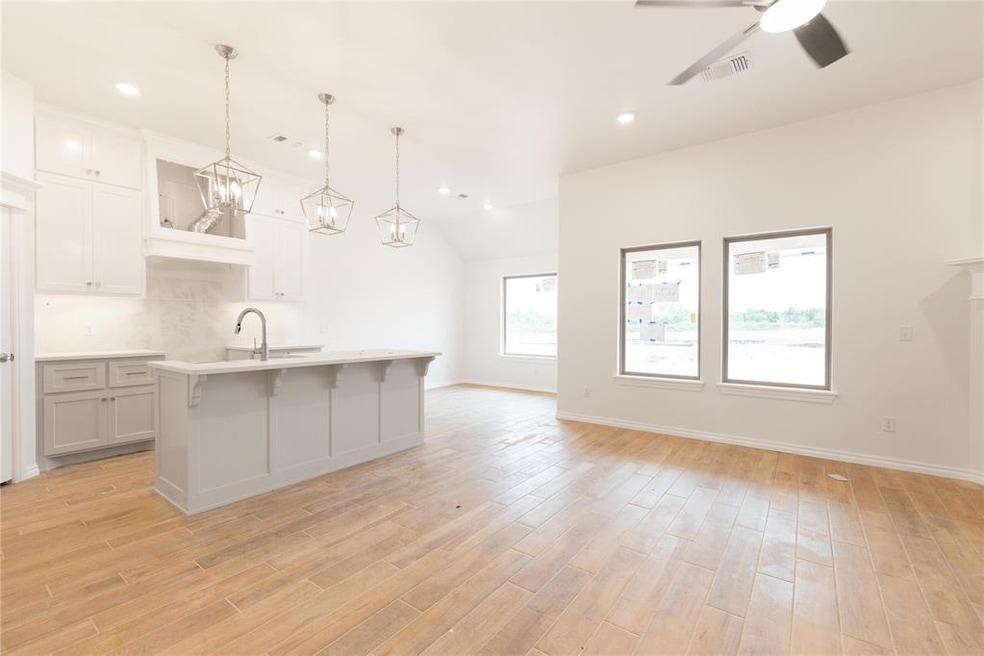 Kitchen featuring light countertops, a center isla