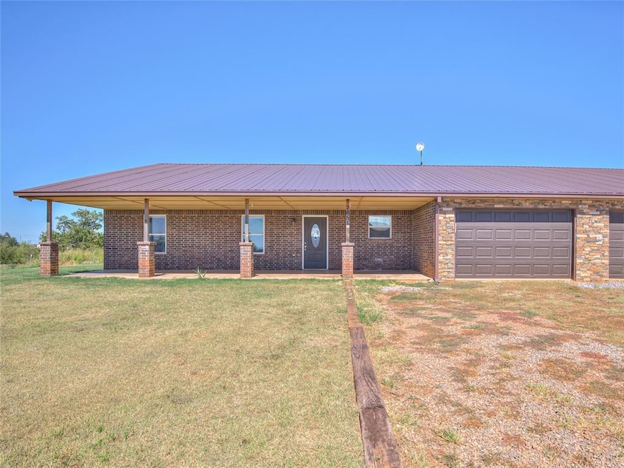 Single story home featuring a front yard and a gar