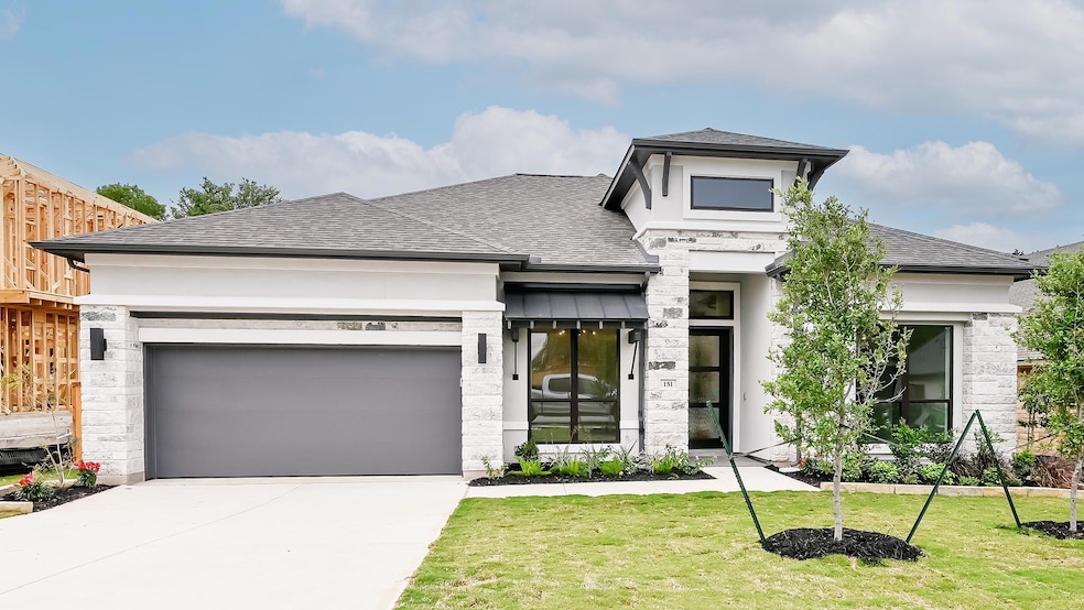 Prairie-style house with a garage, stone siding, 