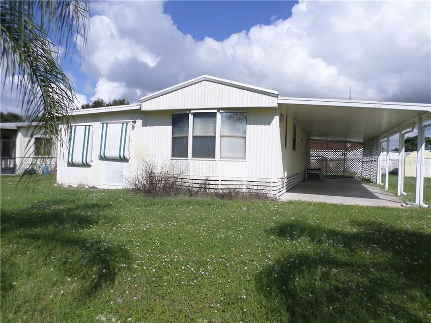 FRONT WITH AWNINGS AND 2 CAR CARPORT
