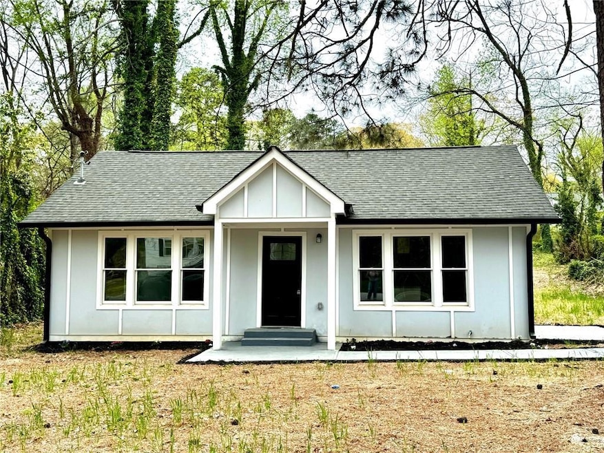 View of front of property with a shingled roof