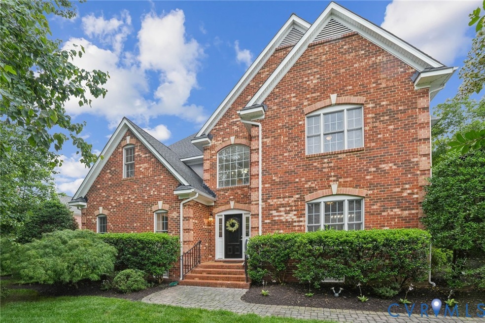 Traditional-style house with brick siding