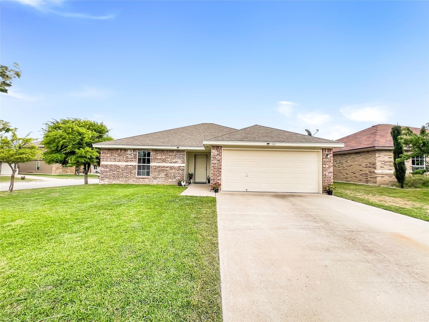 View of front of home featuring driveway, a garag