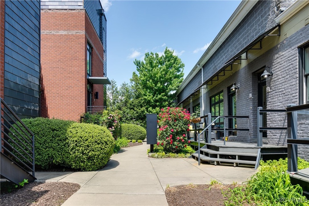 Community entry courtyard in warmer season. Coded