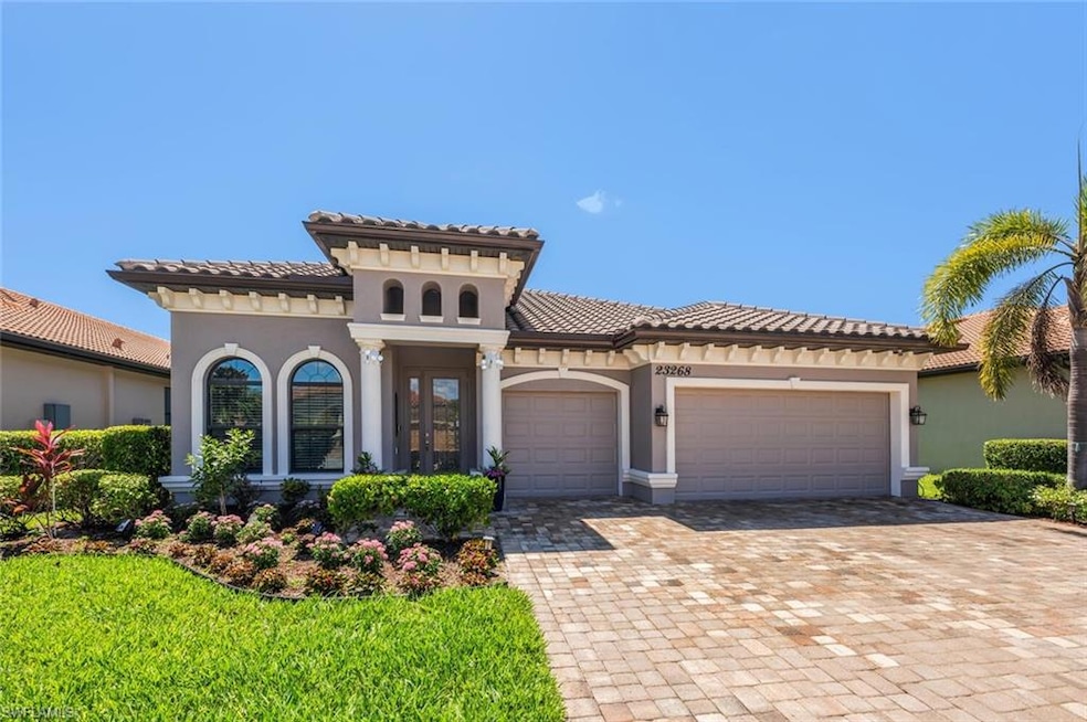 Mediterranean / spanish house featuring stucco siding, a tiled roof, decorative driveway, and a garage