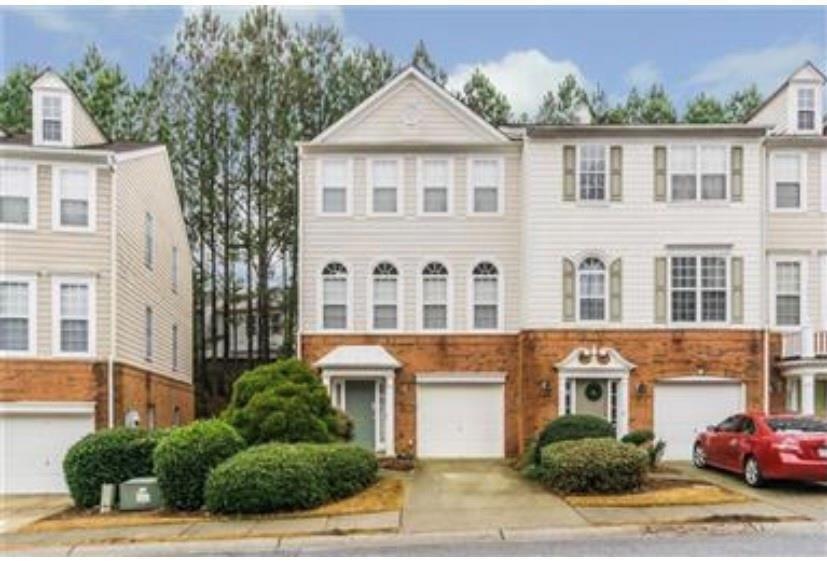 Townhome / multi-family property featuring a garag