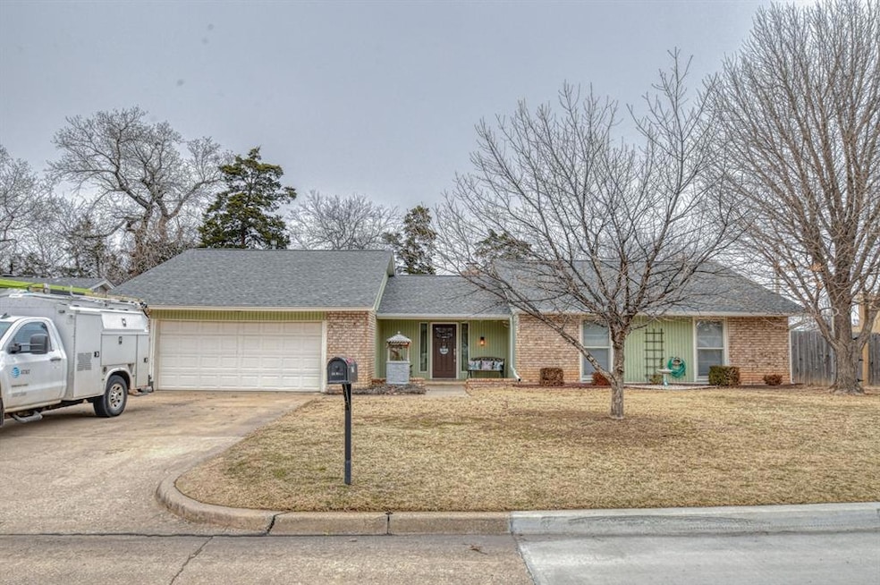 Ranch-style home with a front lawn and a garage