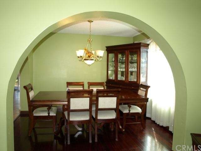Arch Entry Dining Room with Dark Wood Floors
