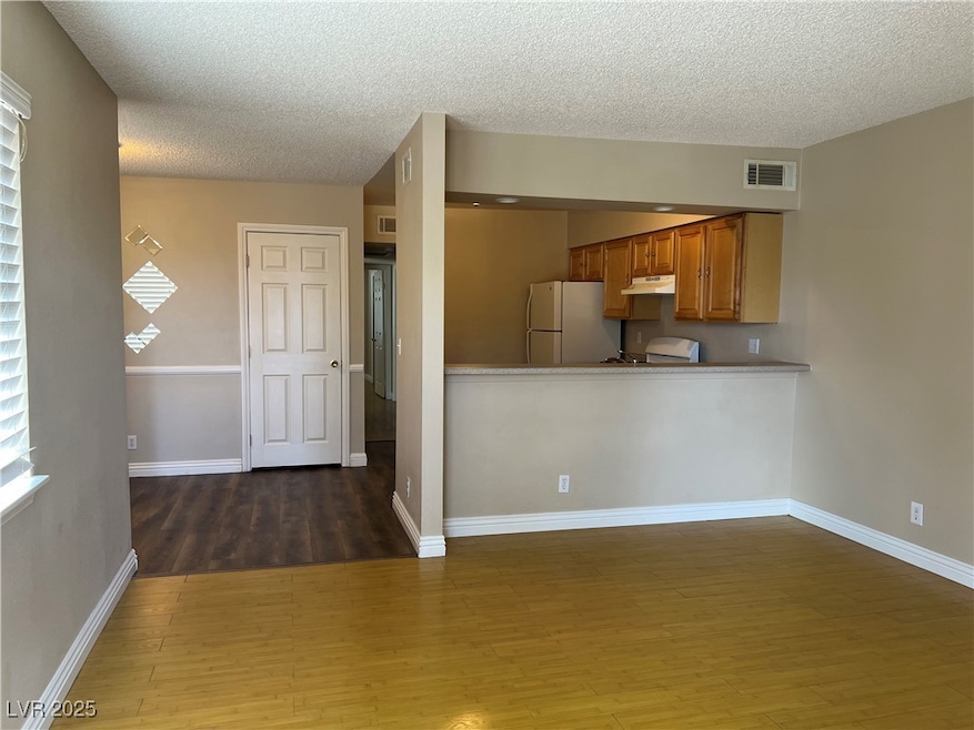 Kitchen featuring freestanding refrigerator, under