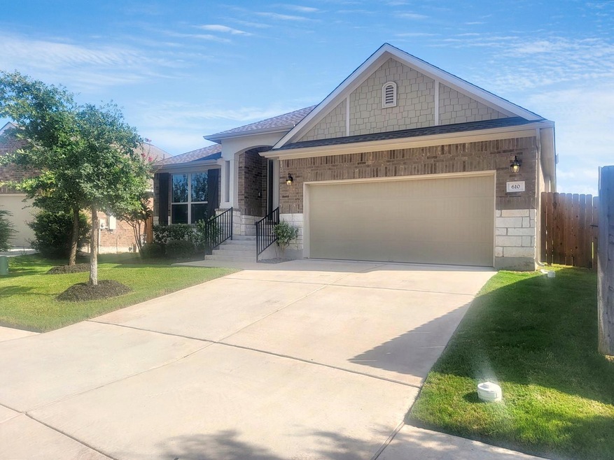 View of front of home with driveway, an attached 