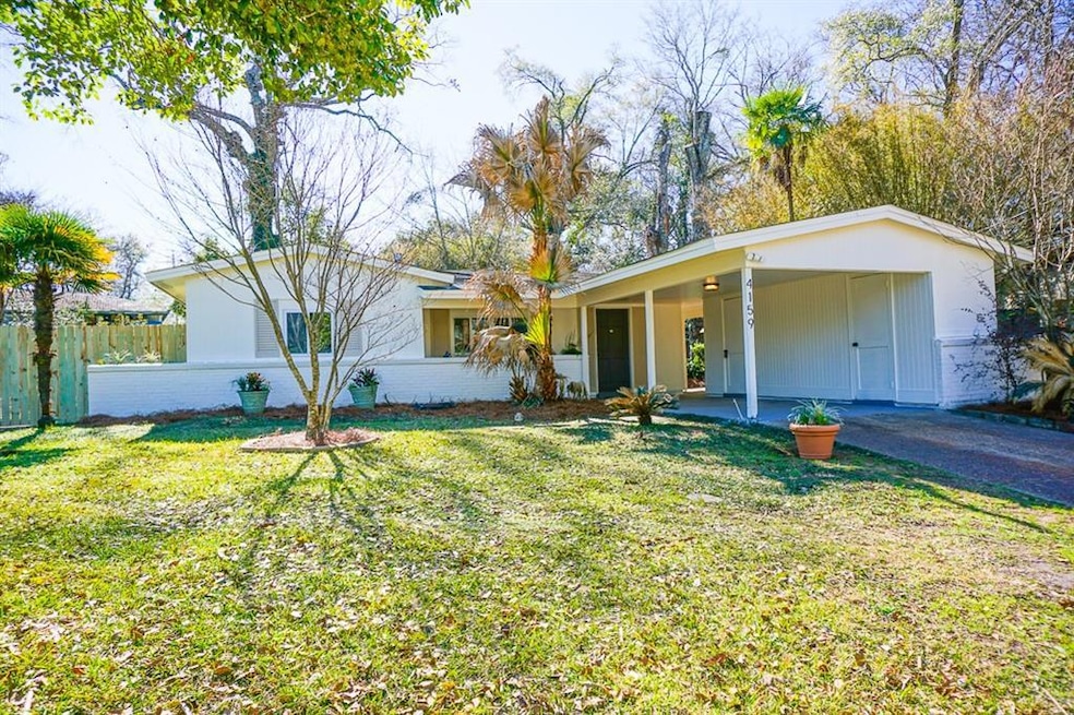 Single story home with a carport, a front lawn, fe
