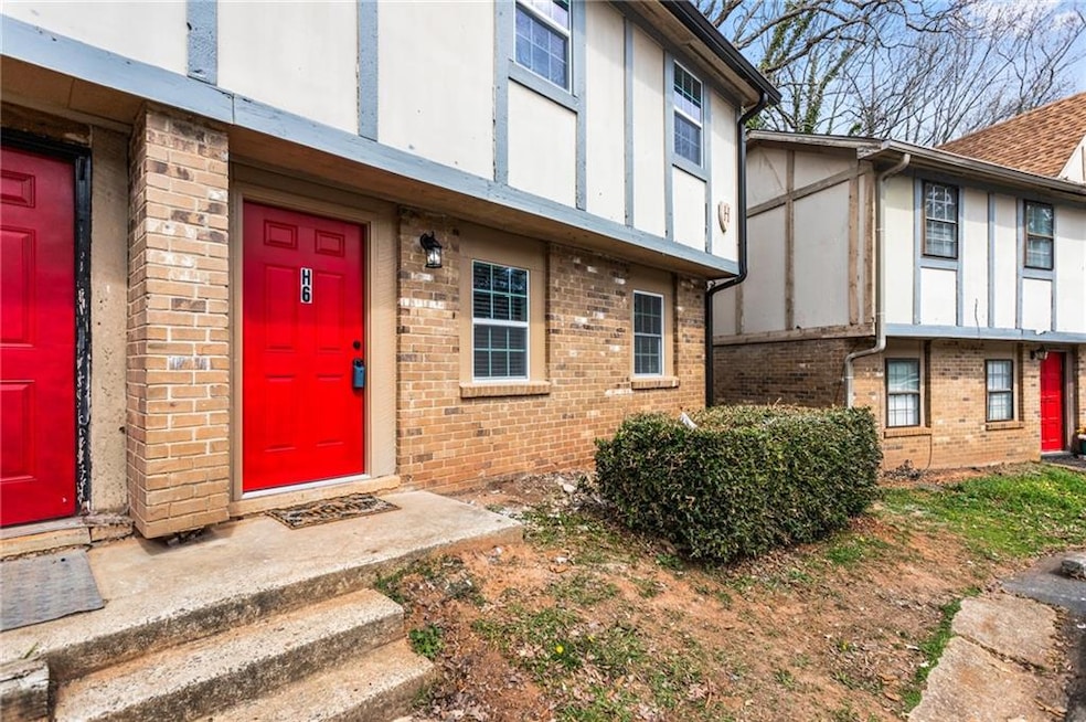 View of exterior entry featuring brick siding
