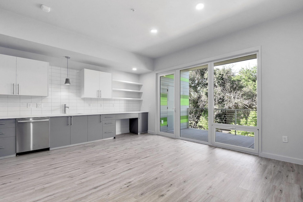Kitchen featuring dishwasher, gray cabinets, ligh